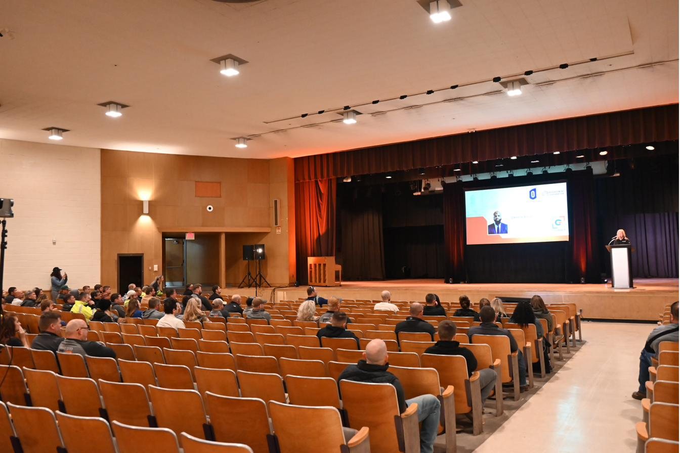 A community gathering filling the AC3 auditorium